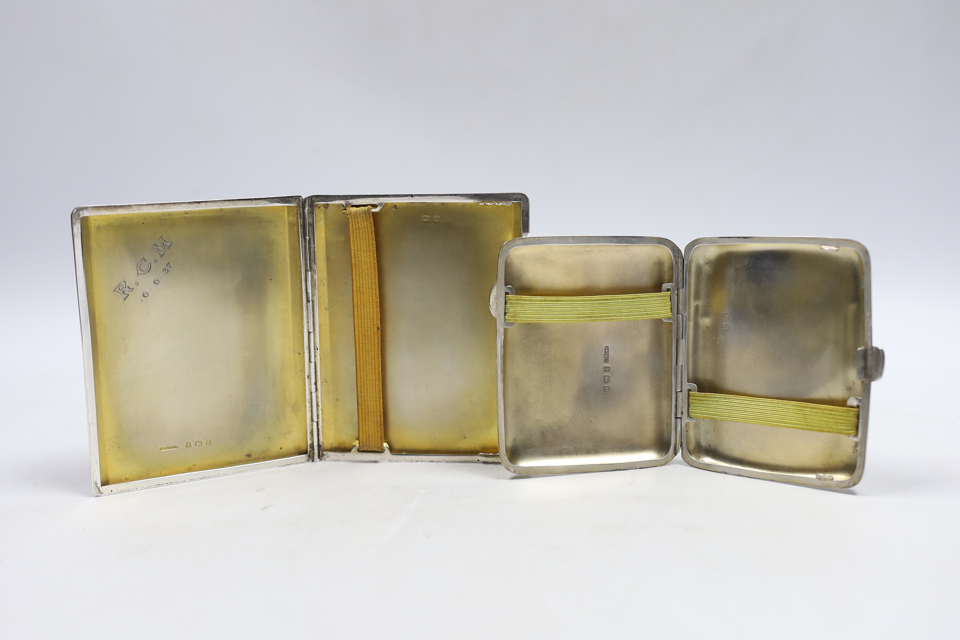 A George V engine turned silver cigarette case, Birmingham, 1935, 10.2cm and one other earlier silver cigarette case.